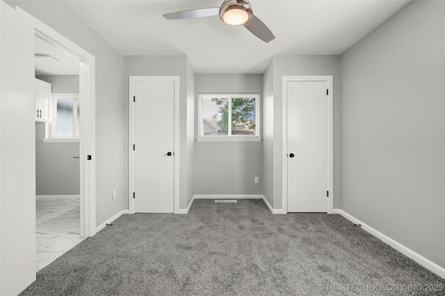 11607 E 24th St, Tulsa, OK 74129 - unfurnished bedroom with baseboards, marble look tiles, ceiling fan, and multiple closets