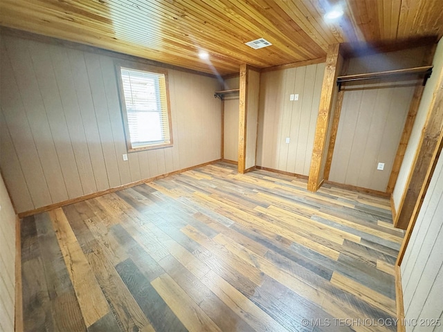15588 N Sunset Valley Rd, Hulbert, OK 74441 - unfurnished bedroom with wood-type flooring, wooden ceiling, multiple closets, and wood walls