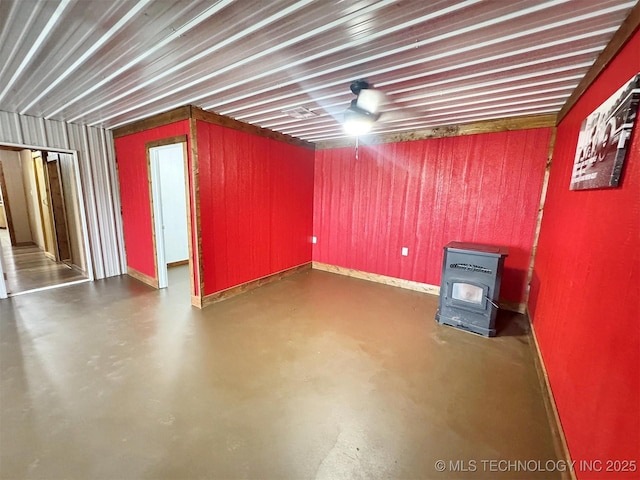 15588 N Sunset Valley Rd, Hulbert, OK 74441 - below grade area featuring a wood stove and baseboards