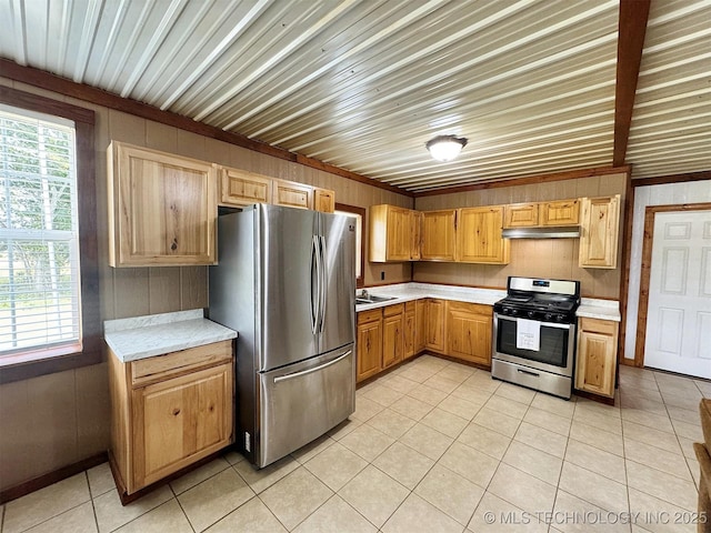 15588 N Sunset Valley Rd, Hulbert, OK 74441 - kitchen featuring stainless steel appliances, light countertops, light tile patterned flooring, under cabinet range hood, and wooden walls