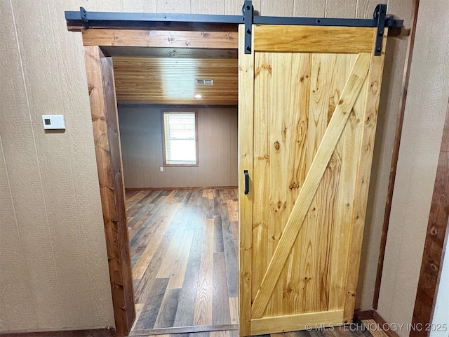 15588 N Sunset Valley Rd, Hulbert, OK 74441 - hall with a barn door, hardwood / wood-style flooring, and a textured wall