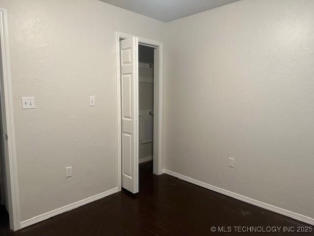 16 Q St SW, Ardmore, OK 73401 - spare room with baseboards and wood finished floors