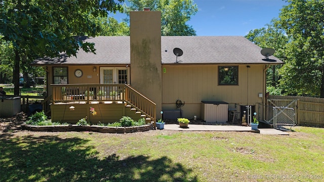 62820 E 312th Rd, Grove, OK 74344 - rear view of property featuring a chimney, a wooden deck, stairs, roof with shingles, and a gate
