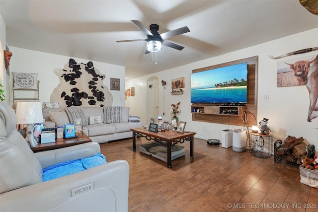62820 E 312th Rd, Grove, OK 74344 - living room featuring arched walkways, ceiling fan, and wood finished floors