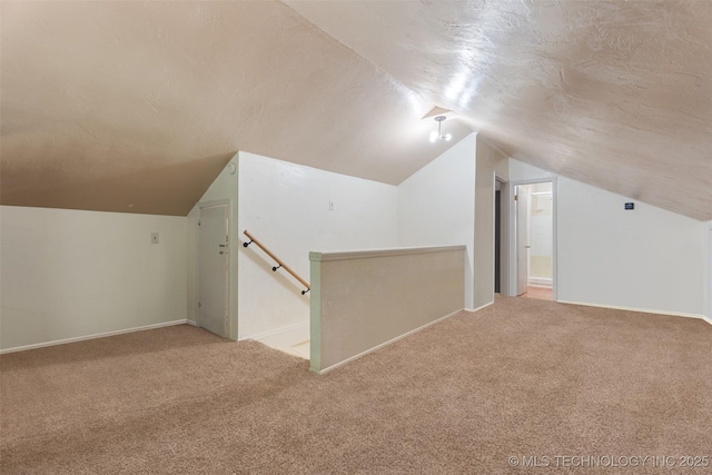 62820 E 312th Rd, Grove, OK 74344 - bonus room featuring carpet floors, vaulted ceiling, baseboards, and a textured ceiling