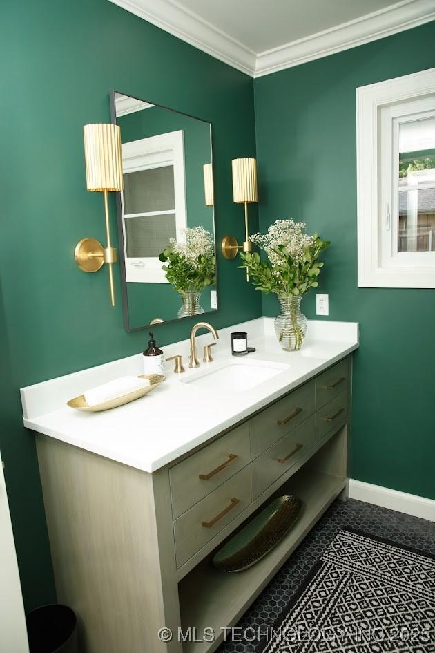 2233 E 32nd St, Tulsa, OK 74105 - bathroom featuring vanity, crown molding, and baseboards
