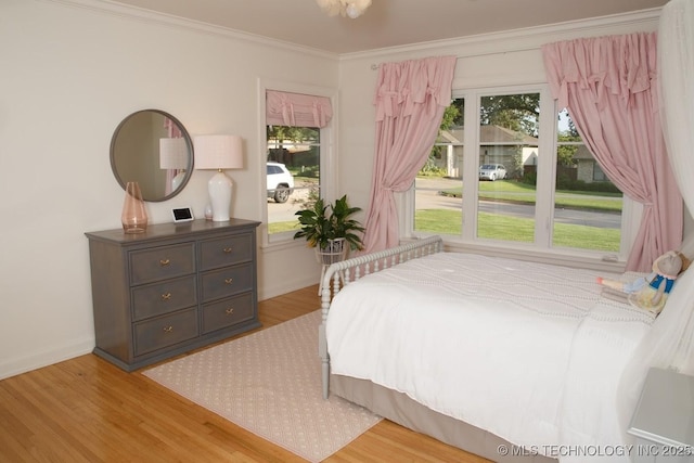 2233 E 32nd St, Tulsa, OK 74105 - bedroom with wood finished floors, ornamental molding, and baseboards