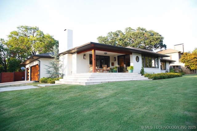 2233 E 32nd St, Tulsa, OK 74105 - view of front of home featuring a chimney, covered porch, a garage, and a front yard