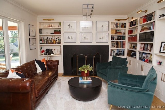 2233 E 32nd St, Tulsa, OK 74105 - living area featuring built in shelves, ornamental molding, and wood finished floors