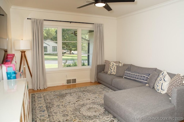2233 E 32nd St, Tulsa, OK 74105 - living area with crown molding, wood finished floors, a ceiling fan, and baseboards