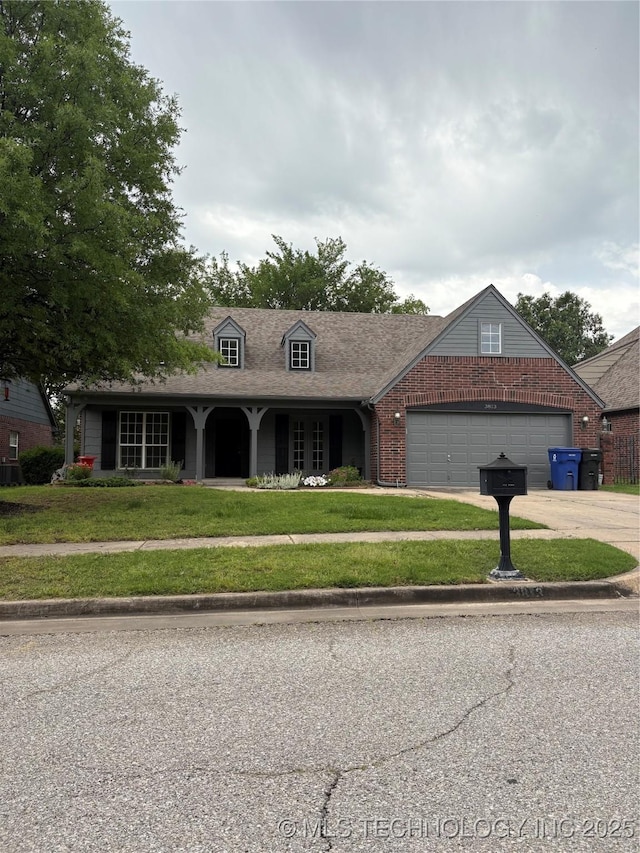 3813 W Dallas St, Broken Arrow, OK 74012 - view of front of house featuring a front lawn, brick siding, a garage, and driveway