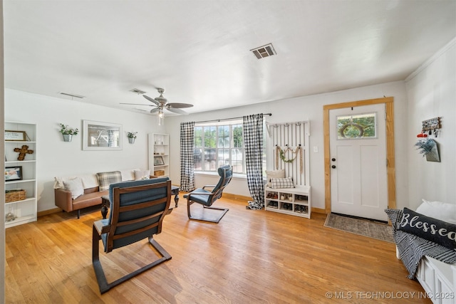 303 SE 3rd St, Pryor, OK 74361 - living area featuring light wood finished floors, a ceiling fan, and baseboards