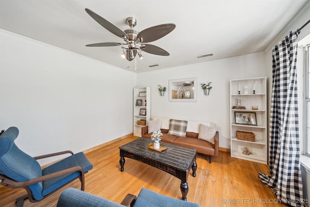 303 SE 3rd St, Pryor, OK 74361 - living room featuring a ceiling fan, wood finished floors, and baseboards