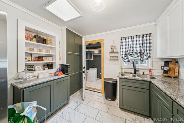 303 SE 3rd St, Pryor, OK 74361 - kitchen with green cabinetry, a sink, crown molding, light marble finish floors, and decorative backsplash