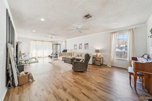 303 SE 3rd St, Pryor, OK 74361 - living area featuring a textured ceiling, a ceiling fan, crown molding, wood finished floors, and recessed lighting