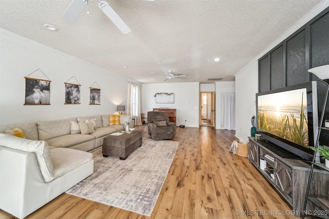 303 SE 3rd St, Pryor, OK 74361 - living area with ceiling fan, ornamental molding, a textured ceiling, and light wood-type flooring