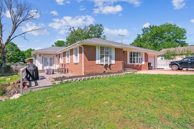 303 SE 3rd St, Pryor, OK 74361 - ranch-style home featuring brick siding, french doors, and a patio area