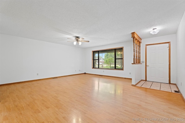 1558 E N Ridge Dr, Vinita, OK 74301 - unfurnished room with wood finished floors, ceiling fan, a textured ceiling, and baseboards
