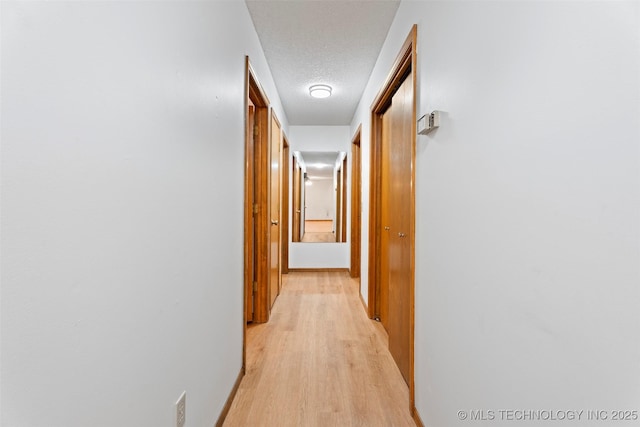 1558 E N Ridge Dr, Vinita, OK 74301 - hall with a textured ceiling and light wood-style flooring