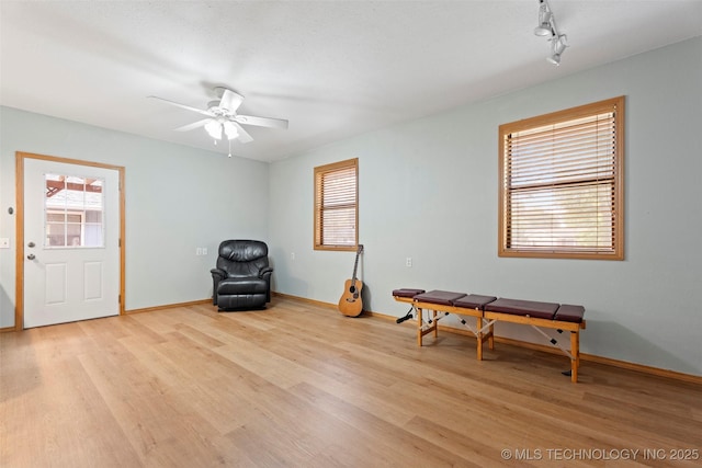 1558 E N Ridge Dr, Vinita, OK 74301 - living area with light wood-style floors, a ceiling fan, and baseboards