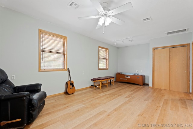 1558 E N Ridge Dr, Vinita, OK 74301 - living area with light wood-style floors, a ceiling fan, and baseboards