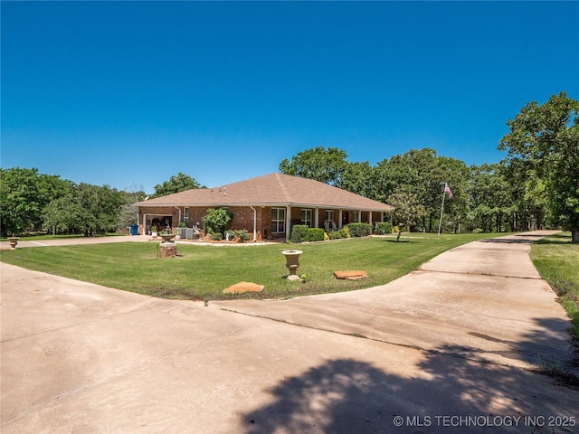 20 Quail, Mcalester, OK 74501 - view of front of property featuring driveway, a front yard, a garage, and brick siding