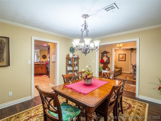20 Quail, Mcalester, OK 74501 - dining area with ornamental molding, a chandelier, wood finished floors, and baseboards
