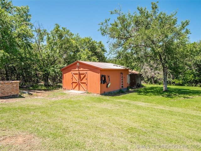 20 Quail, Mcalester, OK 74501 - view of green lawn featuring an outdoor structure and view of wooded area