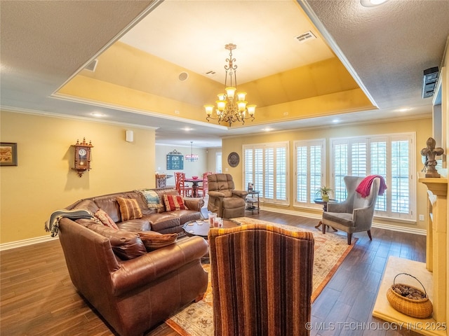 20 Quail, Mcalester, OK 74501 - living room with a chandelier, a raised ceiling, dark wood-type flooring, baseboards, and crown molding