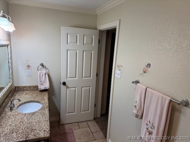 20 Quail, Mcalester, OK 74501 - bathroom featuring crown molding, vanity, stone tile floors, and baseboards