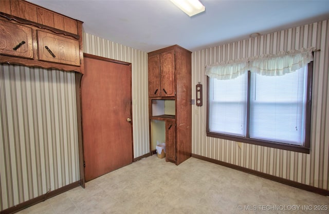 4120 W 53rd St S, Muskogee, OK 74401 - unfurnished bedroom featuring wallpapered walls, light flooring, baseboards, and a closet
