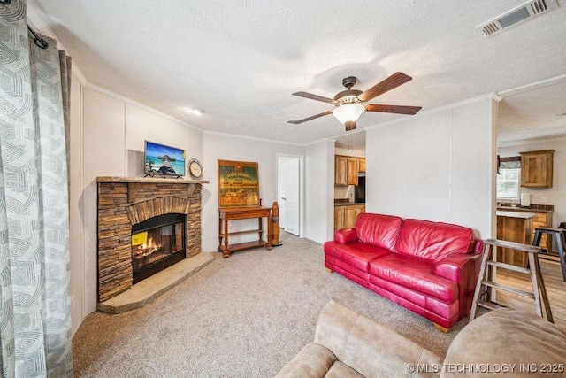 150 Private Road 121, Eucha, OK 74342 - living room featuring ornamental molding, a ceiling fan, light colored carpet, a stone fireplace, and a textured ceiling