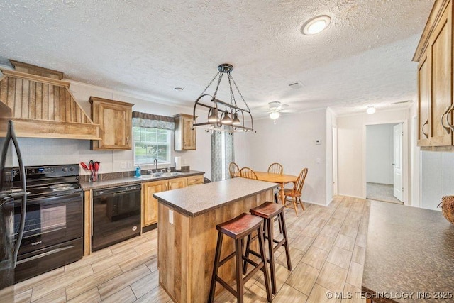 150 Private Road 121, Eucha, OK 74342 - kitchen featuring black appliances, dark countertops, a kitchen island, wood finish floors, and a kitchen breakfast bar