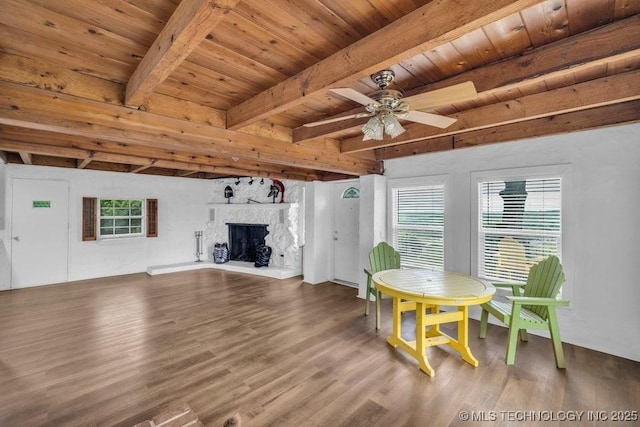 326 E 437th Rd, Spavinaw, OK 74366 - dining room featuring wood finished floors, wooden ceiling with exposed beams, a ceiling fan, and a fireplace