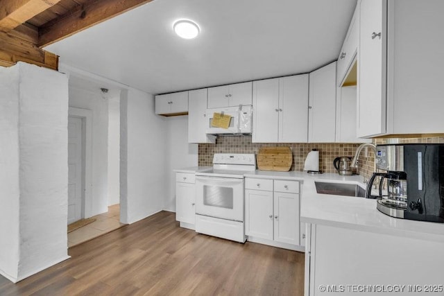326 E 437th Rd, Spavinaw, OK 74366 - kitchen featuring white appliances, decorative backsplash, light countertops, light wood-type flooring, and white cabinets