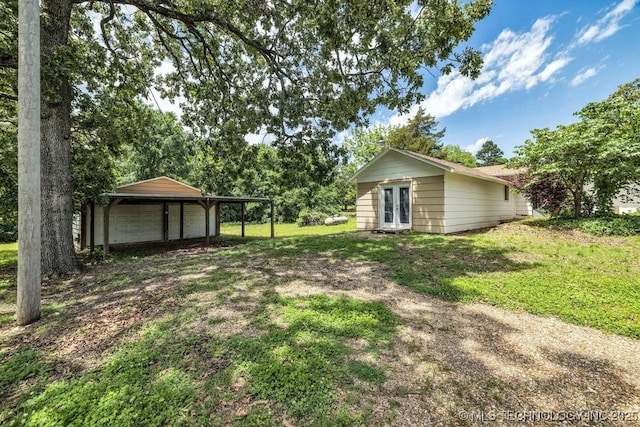 326 E 437th Rd, Spavinaw, OK 74366 - view of green lawn featuring french doors and a detached garage