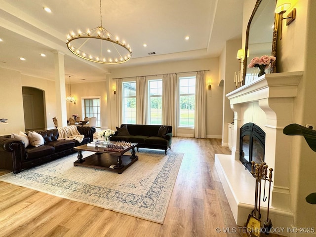 20115 W 111th St S, Sapulpa, OK 74066 - living area with a chandelier, a raised ceiling, wood finished floors, a glass covered fireplace, and recessed lighting