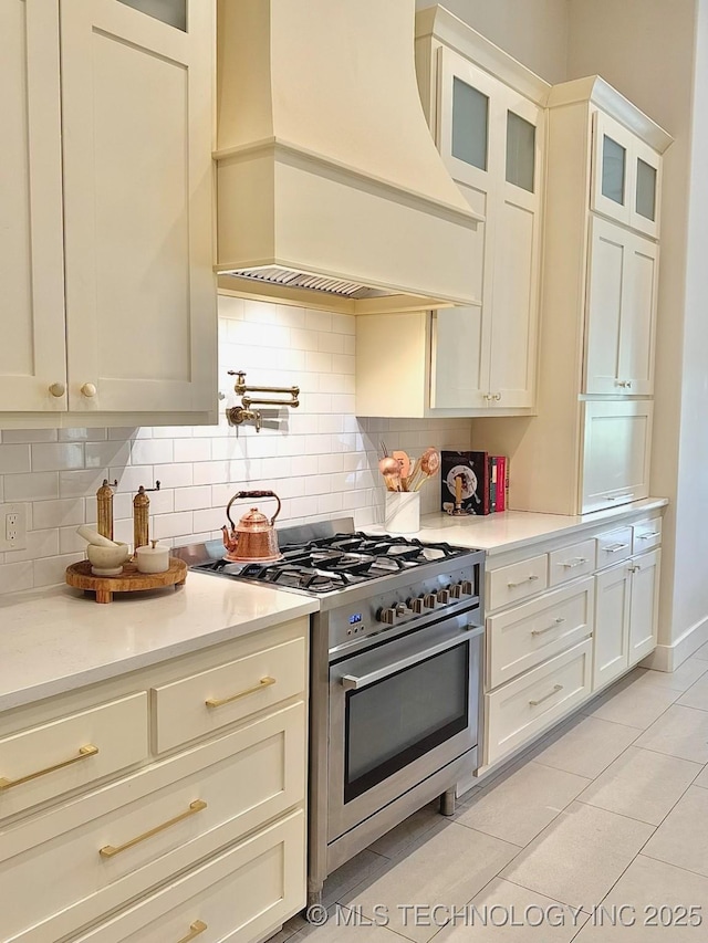 20115 W 111th St S, Sapulpa, OK 74066 - kitchen with custom exhaust hood, stainless steel range, light countertops, and decorative backsplash