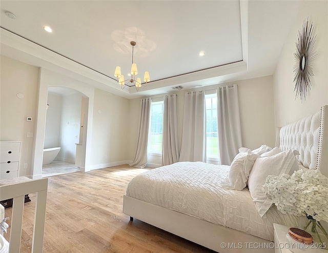 20115 W 111th St S, Sapulpa, OK 74066 - bedroom with arched walkways, a raised ceiling, a chandelier, light wood-type flooring, and recessed lighting