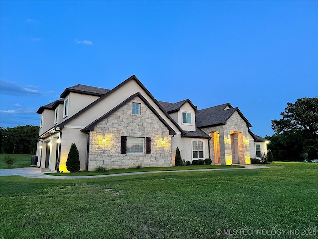 20115 W 111th St S, Sapulpa, OK 74066 - french provincial home featuring stone siding, a front yard, driveway, stucco siding, and a garage