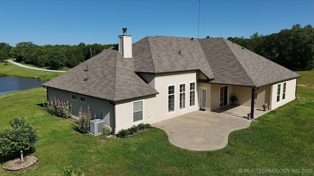 20115 W 111th St S, Sapulpa, OK 74066 - rear view of house with roof with shingles, stucco siding, central AC unit, a chimney, and a patio