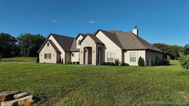 20115 W 111th St S, Sapulpa, OK 74066 - french country home featuring stone siding, a chimney, and a front yard