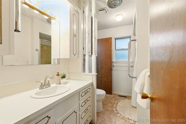 73645 Cyclone Cir, Wagoner, OK 74467 - bathroom featuring vanity, toilet, a textured ceiling, a shower, and tile patterned flooring