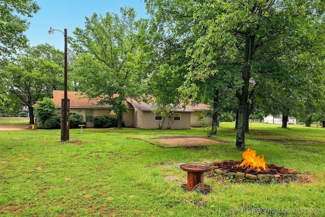 73645 Cyclone Cir, Wagoner, OK 74467 - view of grassy yard featuring an outdoor fire pit