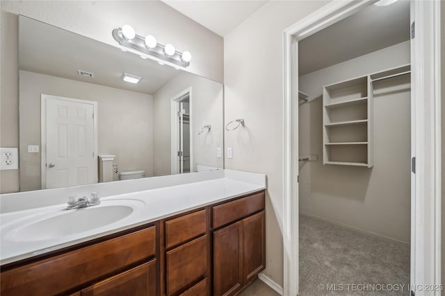 2713 N 20th St, Broken Arrow, OK 74012 - bathroom with vanity, toilet, and a spacious closet