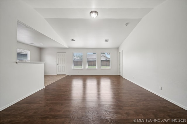 2713 N 20th St, Broken Arrow, OK 74012 - unfurnished living room with vaulted ceiling, wood finished floors, and baseboards