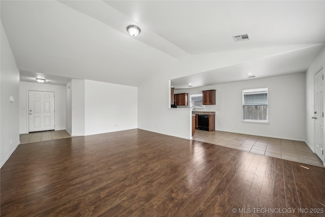 2713 N 20th St, Broken Arrow, OK 74012 - unfurnished living room with wood finished floors, vaulted ceiling, and baseboards