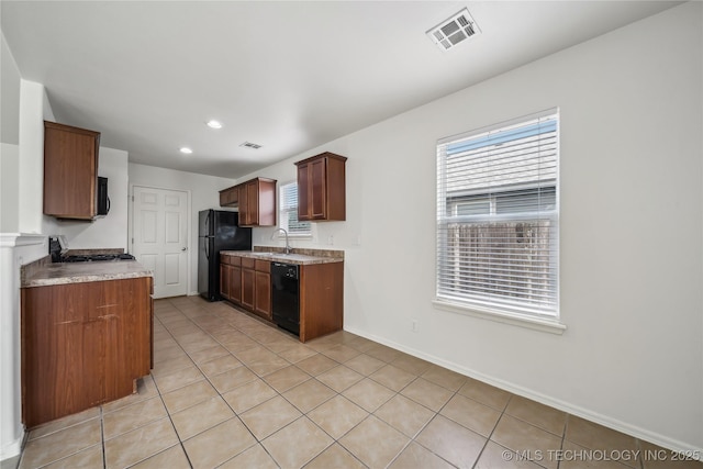 2713 N 20th St, Broken Arrow, OK 74012 - kitchen with black appliances, a sink, light tile patterned floors, light countertops, and recessed lighting