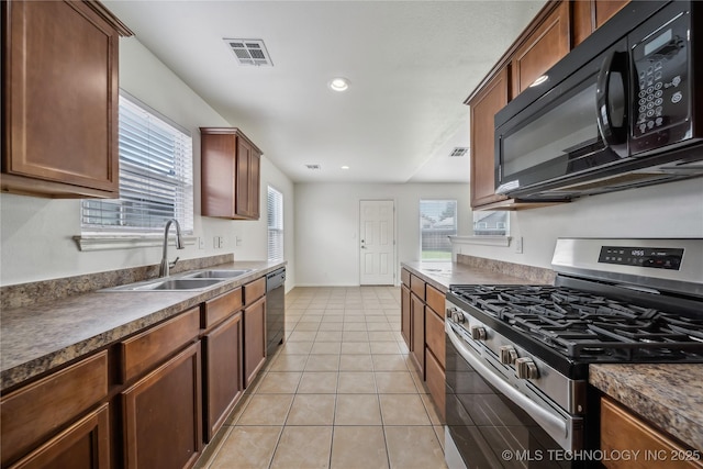 2713 N 20th St, Broken Arrow, OK 74012 - kitchen with stainless steel gas range, black microwave, a sink, dishwashing machine, and dark countertops