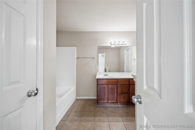 2713 N 20th St, Broken Arrow, OK 74012 - full bathroom featuring vanity, tile patterned floors, a tub, and baseboards